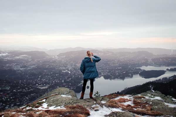 Woman standing on a cliff, Løvstakken, Bergen, Norway.