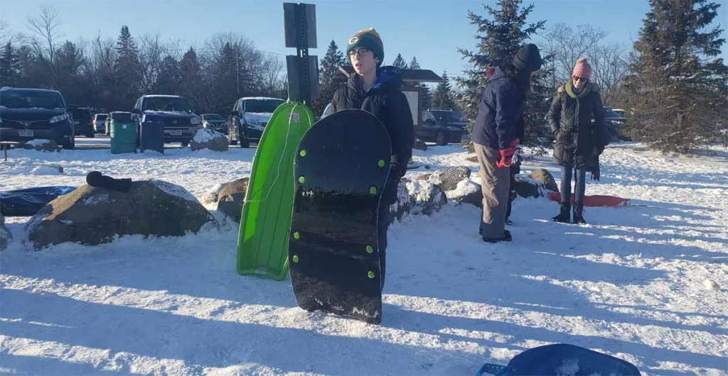 Boy with a sled.